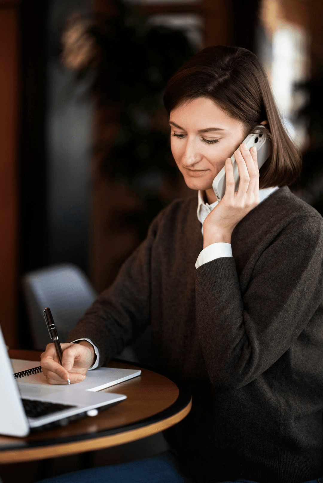 Person on phone taking notes